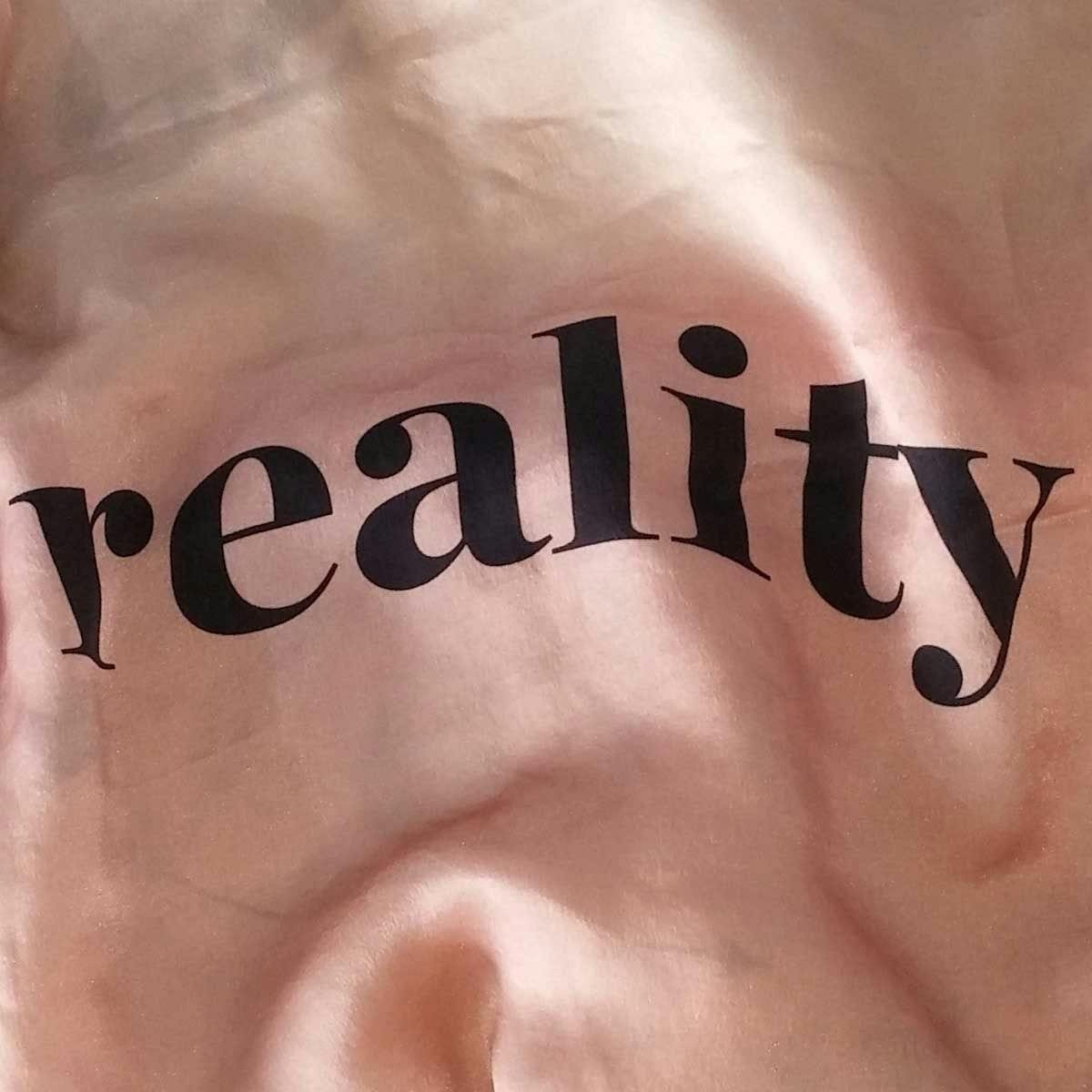 A silk print with the word "reality"